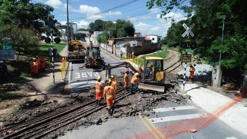 Equipe e maquinário realizando obra de melhoria em passagem de nível ferroviária em Betim/MG